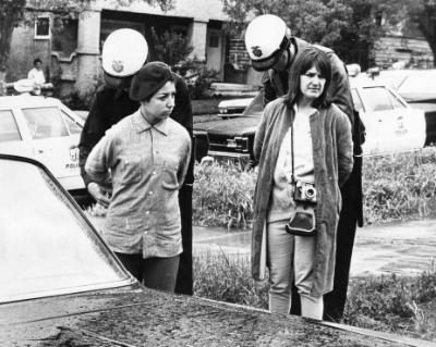 two young women getting arrested by police